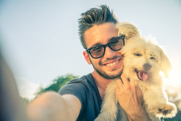 bigstock-Young-Man-And-His-Dog-Taking-A-73517944