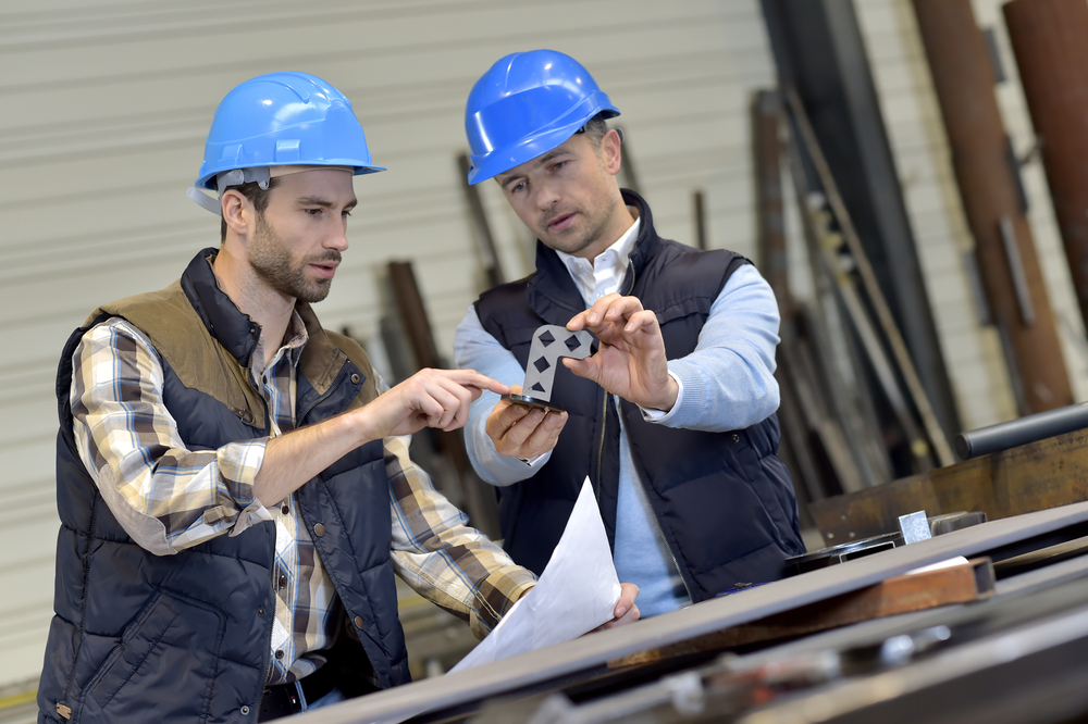 2 men working in a manufacturing factory