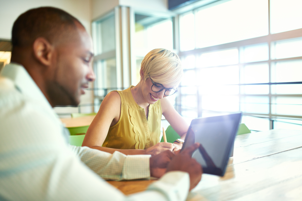 Two business people working with a laptop