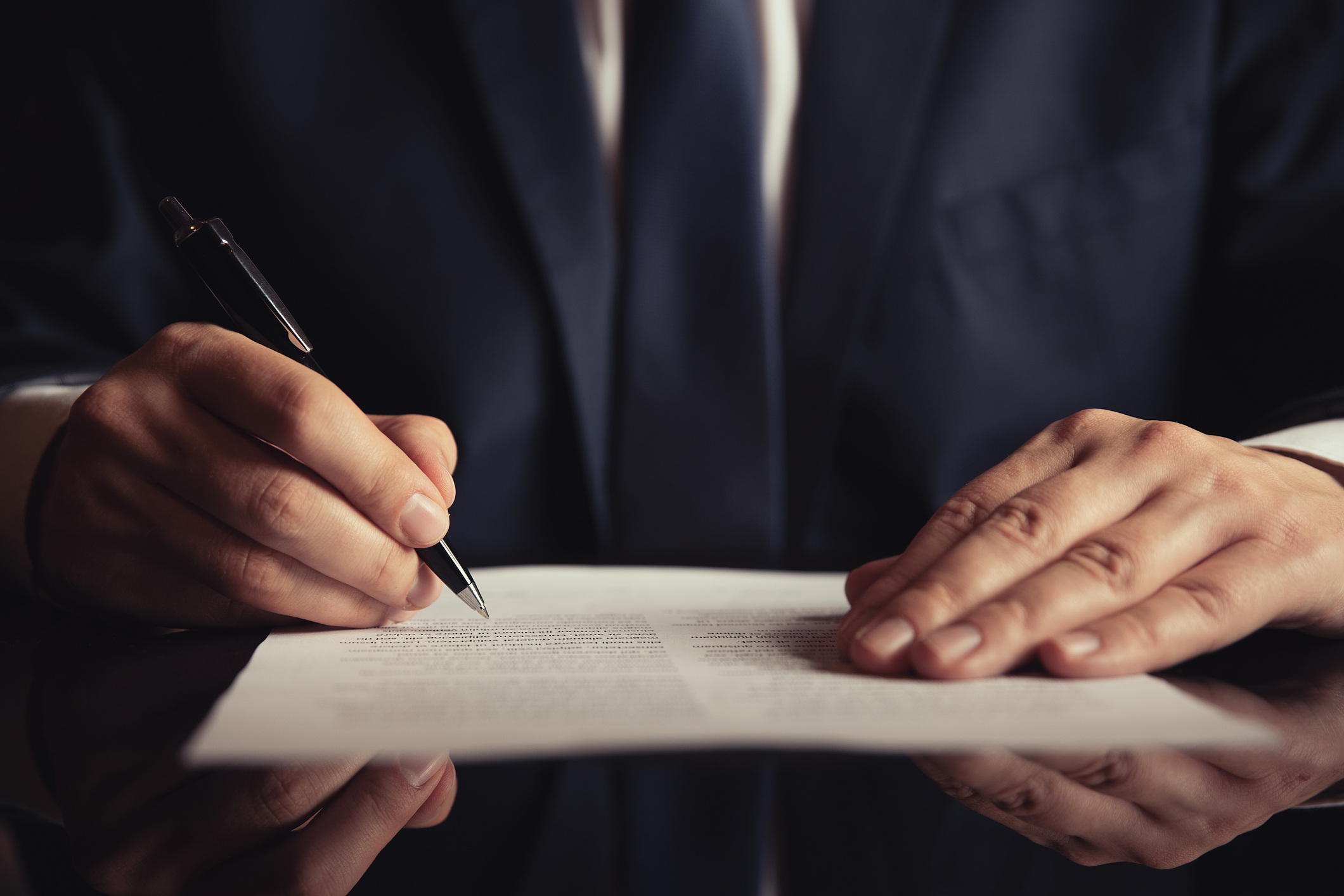 Business person signing a document