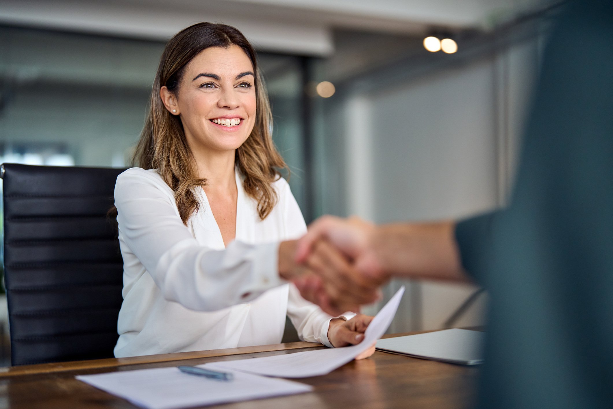 Business woman manager handshaking at office meeting