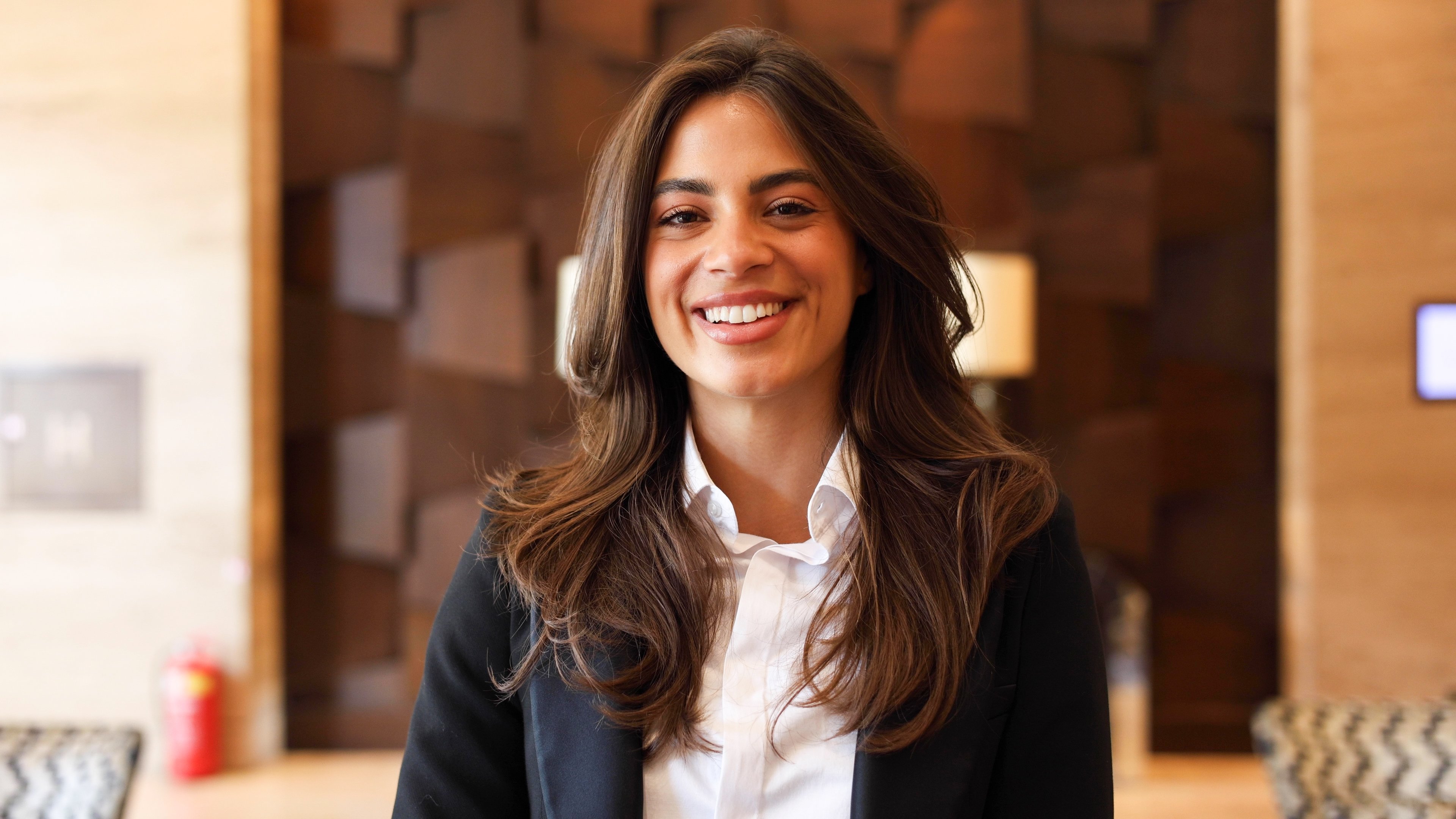 Female agent smiles as she standing at company