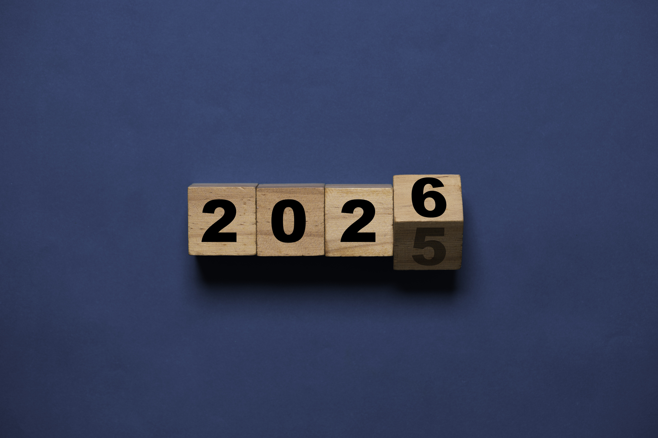 Flipping of 2025 to 2026 on wooden block cube for preparation new year change