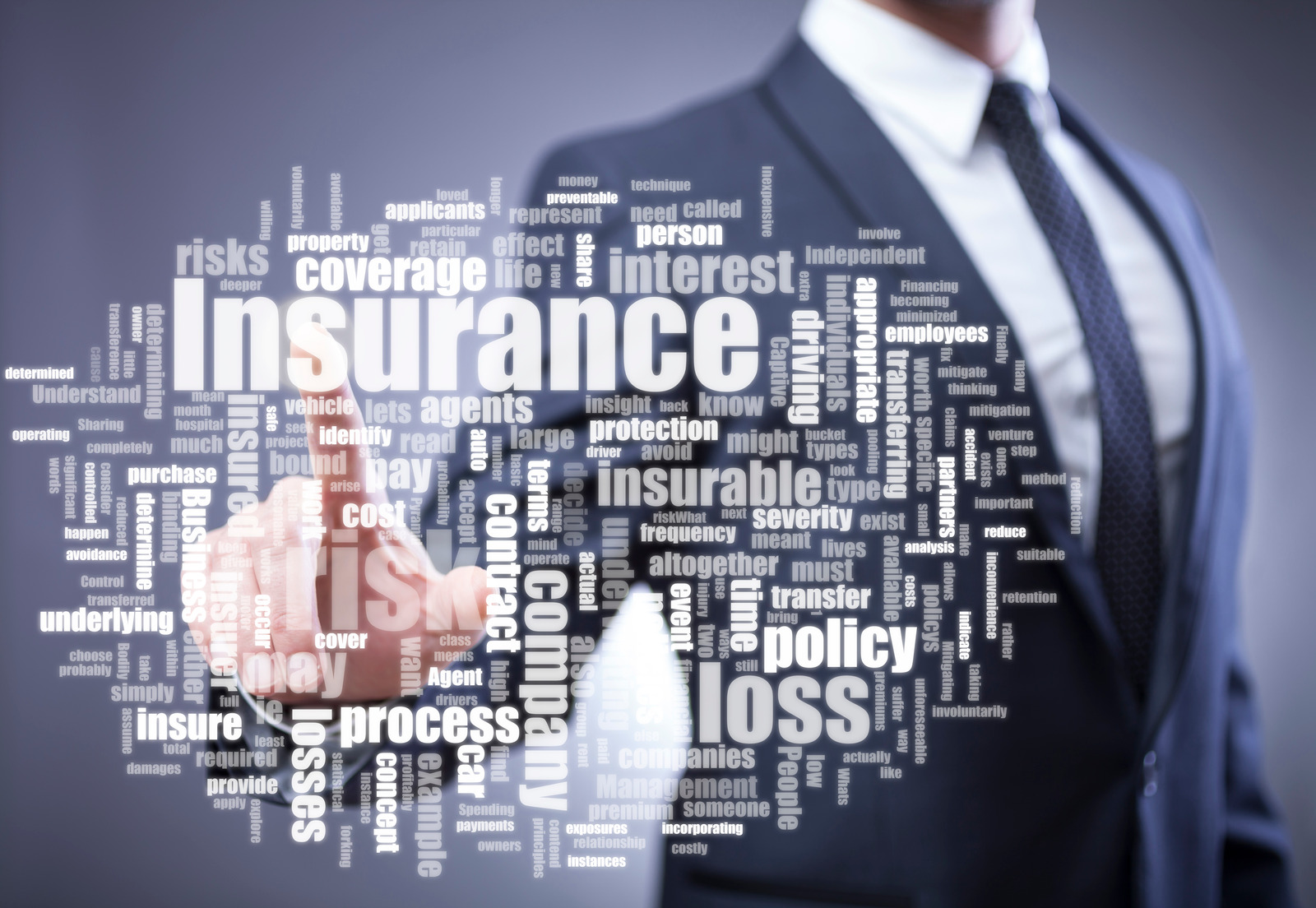 Business man with insurance words on a screen