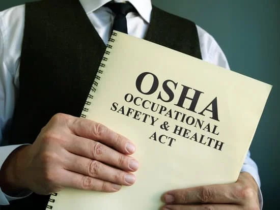 OSHA manual in a man's hands
